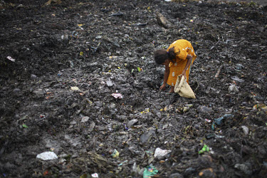 12 year old Hasina collects rubbish for resale. At the end of each day, she earns TK 55 to 70 (USD 1). The Matuail Dump is one of three waste sites in Dhaka, a city of over ten million people. On aver...