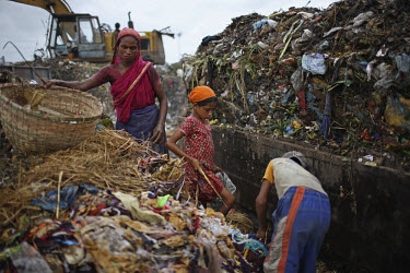 Children and women collecting rubbish for resale. At the end of each day, they earn TK 55 to 70 (USD 1). The Matuail Dump is one of three waste sites in Dhaka, a city of over ten million people. On av...