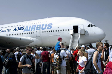 Visitors to the International Aviation Exhibition, held at the Schoenefeld Berlin-Brandenburg airport, stand in front of the Airbus A380. Manufactured by the European corporation Airbus, an EADS subsi...