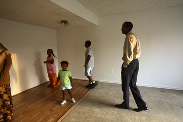 Mohamud Ali, with his wife Fadumo and five children, have a look around their newly purchased home in Manassas, Virginia. At 200,000 USD, the house was bought for half the price it would have been las...