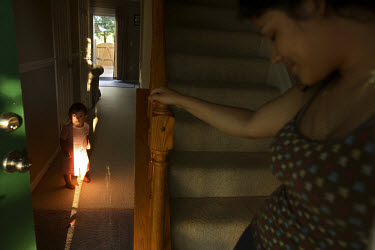 25 year old Elsie Savalba, a Honduran immigrant, in her home in Manassas, Virginia with her one year old daughter Alison. Her house has plummeted in value over the last year from 295,000 USD to 150,00...