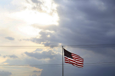 An American flag stands against a darkening sky in Woodbridge, Virginia.