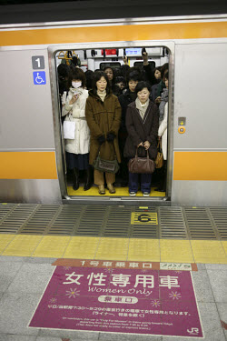 'Women only' carriage waits to depart Shinjuku Station during the morning rush hour. JR (Japan Railways) has 16 tracks at Shinjuku Station and there are 38 tracks if you include the subway and metro l...
