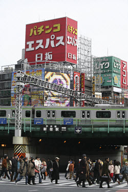 Yamonote line train and people crossing Yasukuni-dori Avenue.