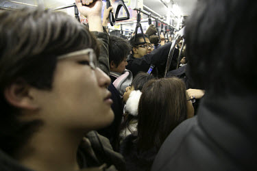 Commuters in a packed metro carriage on their way into Tokyo's Western suburbs.