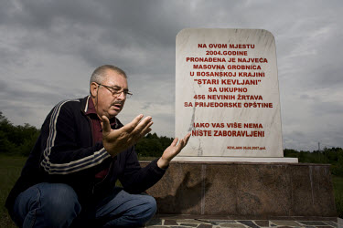 Serif Velic prays next to a memorial to 456 Muslims whose bodies were recovered from a mass grave in this spot in the village of Kevijani in 2004. This area is part of the Republika Srpska, where Bosn...