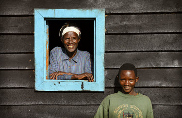 Valerie, who lost her husband and eight children in the 1994 genocide, stands at the window of her new home that was built by Rwanda Aid.