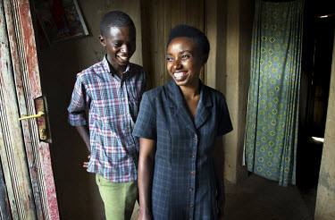 Esther Mukamulinda (right) with her younger brother at her home in Kigali. Her parents were killed during the 1994 genocide and she survived after jumping through a window, but during her escape she w...