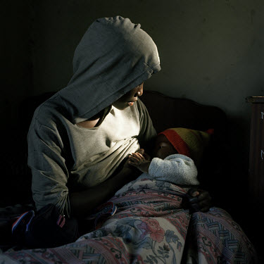 Bukusile Tshosi breastfeeds her 18 month old daughter. As well as looking after her daughter, Bukusile cares for her two younger sisters. Their mother died of Aids seven years ago, and their grandmoth...