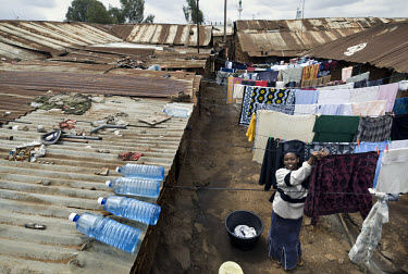 A woman hangs up her washing in the Kibera slums as water bottles sit on her roof in the sun. Many diseases in developing countries are a direct or indirect result of drinking dirty water. One simple solution to this health problem may be an initiative by a Swiss researcher, Martin Wegelin, who is convinced that sunlight (UV radiation) can kill most bacterials. He claims one day of exposure to sunlight makes the water from a plastic bottle bacteria free. Martin Wegelin is co-ordinator of the SODIS (Solar Water Disinfection) project.