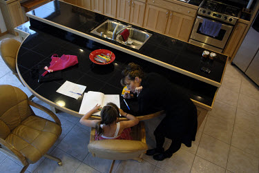 Sarah Palin, Governor of Alaska, helps her daughter Piper with her homework at home in Wasilla. In 2008 she was nominated as the Republican candidate for Vice President.