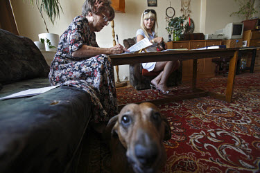 Ewa Rachwal (right) visits a client, Irena Kowalczyk, at her home in Warsaw to make a loan deal. Rachwal is one of more than 28,000 self-employed agents for a British company, International Personal F...