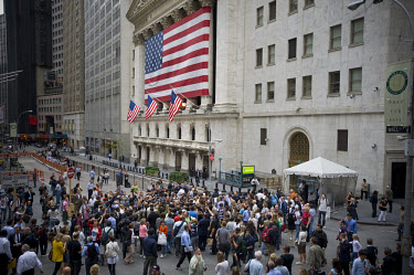 A crowd gathers on Wall Street outside the New York Stock Exchange on the day when share prices plummeted after the US Government failed to reach an agreement to bail out the country's ailing financia...