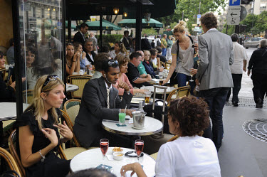 People of the terrace of the famous cafe Les Deux Magots in the fashionable Left Bank district of St Germain des Pres.