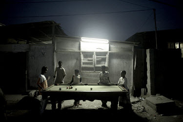 Children play pool in one the poorest neighbourhoods of the coastal town of Aden, where thousands of Somali refugees struggle to survive. With the unemployment rate in Yemen extraordinarily high, at a...