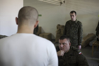 Corporal Rafal Cebra examines a new conscript. This year's class of drafted recruits is the final one after 90 years of compulsory military service, as Poland's army turns professional in 2009.