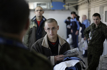 A young conscript waiting in line at the airforce base in Radom. This year's class of drafted recruits is the final one after 90 years of compulsory military service, as Poland's army turns profession...