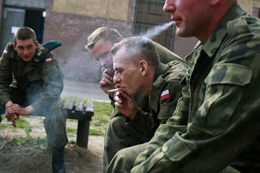 Young soldiers smoke during a break at the military base in Bartoszyce. This year's class of drafted recruits is the final one after 90 years of compulsory military service, as Poland's army turns pro...