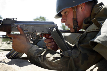 Private Bartek Frajer learning to shoot his AK-47 Kalashnikov rifle. This year's class of drafted recruits is the final one after 90 years of compulsory military service, as Poland's army turns profes...