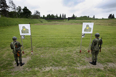 Young soldiers at the shooting range, checking the results of their first practice with AK-47 Kalashnikov rifle. This year's class of drafted recruits is the final one after 90 years of compulsory mil...