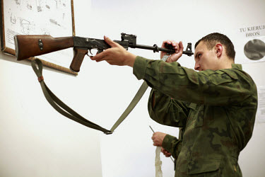 Private Andrzej Kasprzak cleaning his AK-47 Kalashnikov rifle after shooting. This year's class of drafted recruits is the final one after 90 years of compulsory military service, as Poland's army tur...