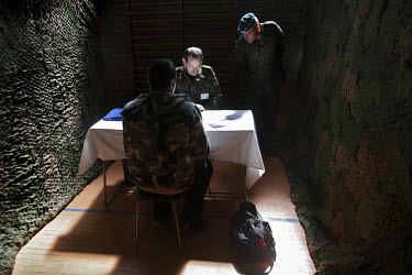 An army officer interviewing a young soldier-to-be, before he enters the military zone in Bartoszyce. This year's class of drafted recruits is the final one after 90 years of compulsory military servi...