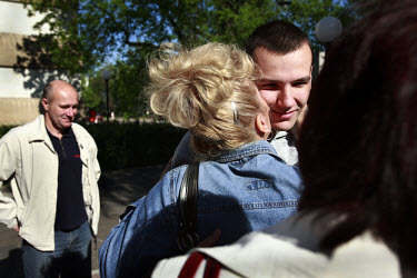 Bartosz Lukasiak says goodbye to his parents as he leaves for his army base in northern Poland. This year's class of drafted recruits is the final one after 90 years of compulsory military service, as...