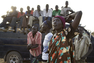 A young woman watches a volleyball match at the Twic Olympics in Wunrok, Southern Sudan.