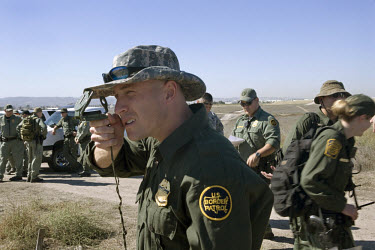 A group of US border patrol agents on manoeuvres in California near the Tijuana mountains. As of October 2006 twice as many border patrol agents have been working the border close to Tijuana.