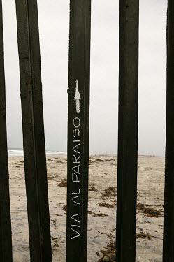 Graffiti written in one of the railings which separates Mexico and the USA in Playas de Tijuana: This Way to Paradise.