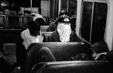 Mexican illegal immigrants hide their faces as they travel on a bus in California. It is estimated that there are around 6.3 million Mexicans living and working illegally in the United States, and alt...