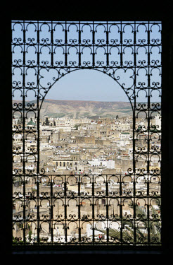 View of the medina through a window with metalwork in the Riyad Moqri. This Riyad was constructed in the beginning of the 20th Century by Driss Moqri. The palace is now home to an institute for tradit...