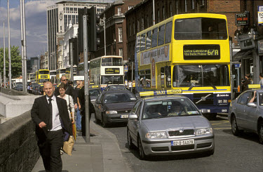Cars and buses sit in rush hour traffic in the city centre.