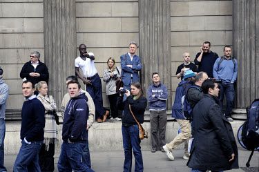 People watch the demonstration at the Bank of England as thousands of protestors descended on the City of London ahead of the G20 summit of world leaders to express anger at the economic crisis, which...