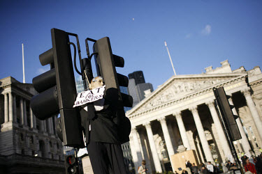 An effigy of a banker is hung from a lamp post outside the Bank of England (left) and the Royal Exchange. Thousands of protestors descended on the City of London ahead of the G20 summit of world leade...