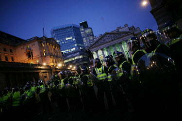 Riot police form a line in front of the Bank of England (left) and Royal Exchange, coralling protestors in a 'kettle' to prevent trouble spreading. Thousands of protestors descended on the City of Lon...