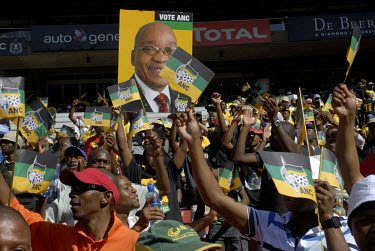 Crowds wave ANC flags and hold up pictures of Jacob Zuma at an African National Congress (ANC) election rally held at the Ellis Park Stadium in Johannesburg.