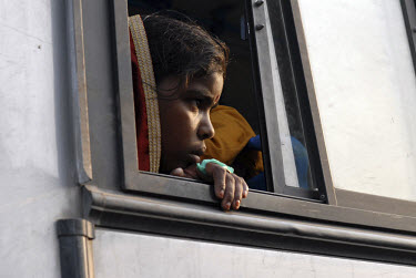 Child on a bus stuck in a traffic jam in central Delhi.