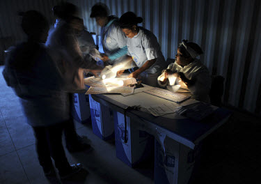 A polling station in the Du Noon squatter area on the day of the 2009 general election. Election officials ready themselves for the start of voting in the pre-dawn light.