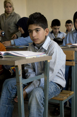 13 year old Hussein Zourayk in class at the Tanshiah school. Hussein lost his leg in April 2008 when a cluster sub-munition exploded in a field near his home. There remain hundreds of thousands of ite...