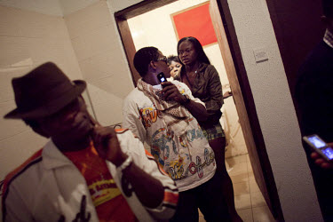 Aspiring hip hop star Daniel, who performs under the name Blacktribe (left), with friends in the bathroom of a nightclub in a middle class neighbourhood called Festac.