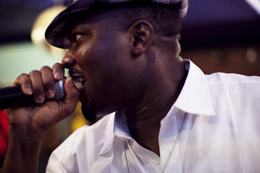 A man sings hip hop as he competes at an open mic and dance contest at a nightclub in the middle class Ikeja neighbourhood.