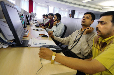Dealers in the trading room of a stock/share company registered on the Bombay Stock Exchange.