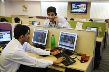 Dealers in the trading room of a stock/share company registered on the Bombay Stock Exchange.