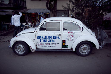 A Volkswagen (VW) Beetle belonging to a driving school in the middle class Suralere neighbourhood.