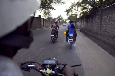 People ride Okadas, which are motorcycle taxis. Okada was the name of Nigeria's first private airline, which had a reputation for being on time and operating with a can-do spirit compared with the nat...