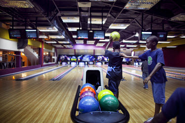 People bowl at The Palms shopping mall, the first of its kind in Nigeria, with big box retailers, a cinema, supermarket and food court. Bowling, a staple of the middle class in many places, is new to...