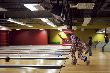 People bowl at The Palms shopping mall, the first of its kind in Nigeria, with big box retailers, a cinema, supermarket and food court. Bowling, a staple of the middle class in many places, is new to...