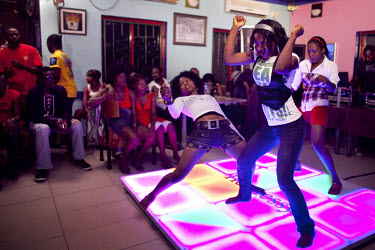 Contestants dance to hip hop music at an open mic and dance contest at a nightclub in the middle class Ikeja neighbourhood.