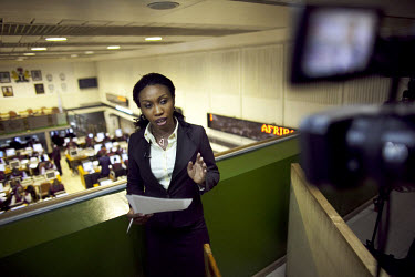 Nancy Illoh, a reporter on The Money Show, a program about finance and stocks on African Independent Television (AIT) broadcasts live from a balcony above the Nigerian Stock Exchange.